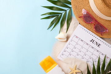 Top view of summer vacation essentials with calendar, hat, and sunglasses, perfect for planning a...