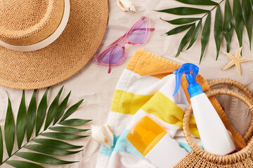 Elaborate display of sun care products and beach accessories, including a straw hat and sunscreen,...