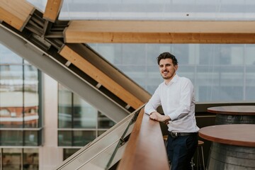 Smiling businessman on the balcony