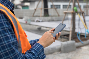 engineer working on  smart phone at the construction site