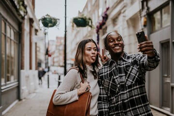 Couple taking selfies on smartphone