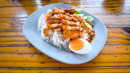 Crispy pork rice on a blue plate on the dining table