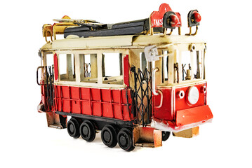 Red vintage tram isolated on white background. A toy replica of a tram.