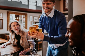 Man getting drinks for friends at a pub