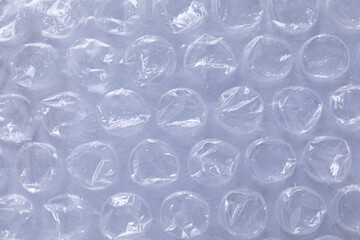 Transparent bubble wrap on gray background, top view