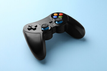 Wireless game controller on light blue background