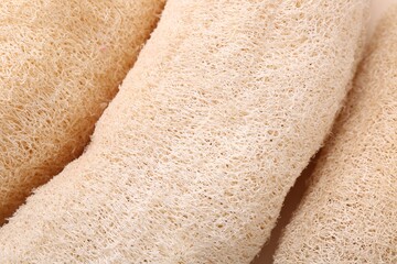 Natural loofah sponges as background, closeup view