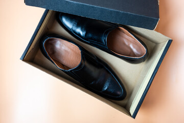 Male black leather shoe, new product on brown box, comfortable footwear for businessman or office...