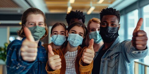 Obraz premium Thumbs up, covid pandemic, and mask-wearing businesspeople display positivity. Coronavirus pandemic, advertising or marketing firm health and safety strategy
