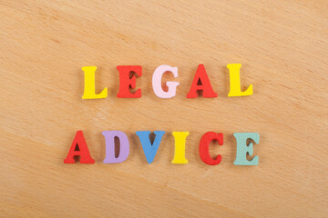 LEGAL ADVICE word on wooden background composed from colorful abc alphabet block wooden letters, copy space for ad text. Learning english concept.