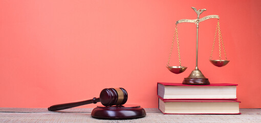 Law concept - Open law book, Judge's gavel, scales, Themis statue on table in a courtroom or law...