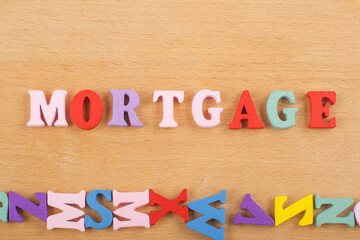 MORTGAGE word on wooden background composed from colorful abc alphabet block wooden letters, copy space for ad text. Learning english concept.