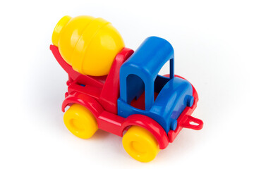 Children's plastic multi-colored toy concrete mixer on a white background. Toy vehicles, outdoor games for children