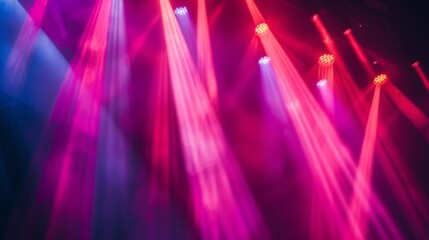 Stage lights casting a colorful glow on the performers and audience at a concert