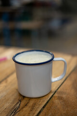 A cup of hot milk on wooden table