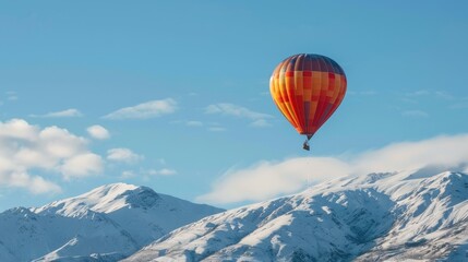 Naklejka premium Hot air balloon floating over snow mountain with copy space area.
