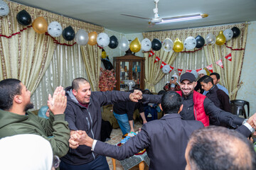 A group of Arab people is dancing and celebrating various occasions such as weddings, graduations,...