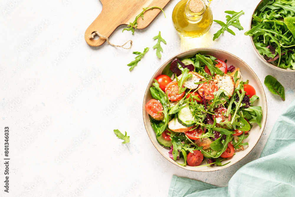 Wall mural healthy food on white table. green salad with baked chicken breast, fresh salad leaves and vegetable