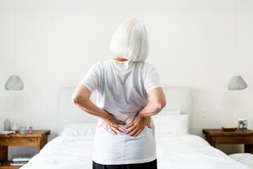 Woman suffering from back pain, health concept image