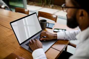 Cool businessman working from home on laptop