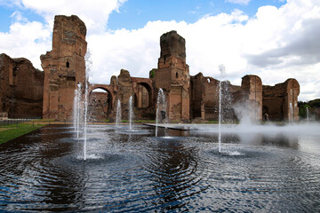 Walls of the Baths of Caracalla in Rome, artificial pool in the foreground inaugurated in 2024 with...