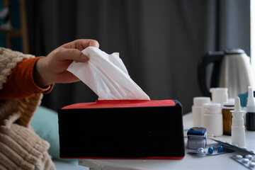 Close-up of Man hand taking pulling white tissue napkin out of from box clean handkerchief