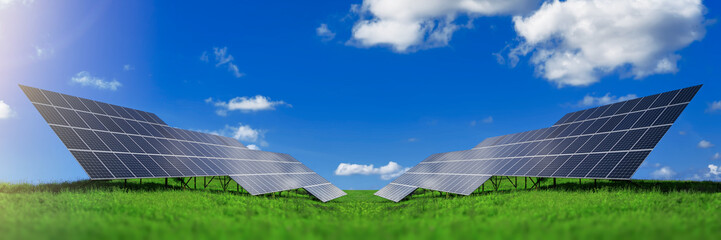 Solar energy panels against blue sky with clouds