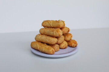 Kaasstengels or Kastengel, is Dutch influenced Indonesian cheese cookies in the form of sticks. Isolated in white background