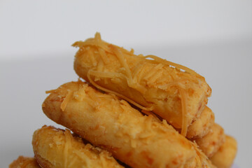 Kaasstengels or Kastengel, is Dutch influenced Indonesian cheese cookies in the form of sticks. Isolated in white background