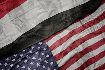 Obraz premium waving colorful flag of united states of america and national flag of yemen on the dollar money background. finance concept.