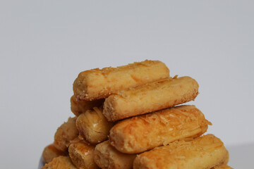 Kaasstengels or Kastengel, is Dutch influenced Indonesian cheese cookies in the form of sticks. Isolated in white background