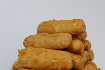 Kaasstengels or Kastengel, is Dutch influenced Indonesian cheese cookies in the form of sticks. Isolated in white background