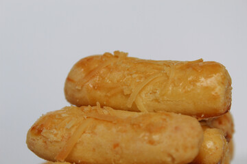 Kaasstengels or Kastengel, is Dutch influenced Indonesian cheese cookies in the form of sticks. Isolated in white background