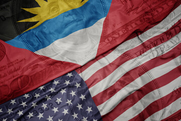 waving colorful flag of united states of america and national flag of antigua and barbuda.