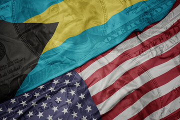 Obraz premium waving colorful flag of united states of america and national flag of bahamas.