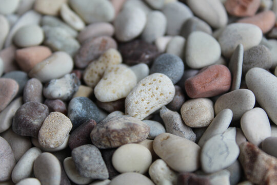 Background texture of pebbles or small river stone, flat lay or top view