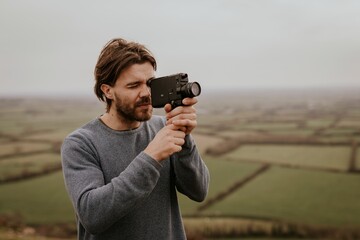 Man recording video with film camera