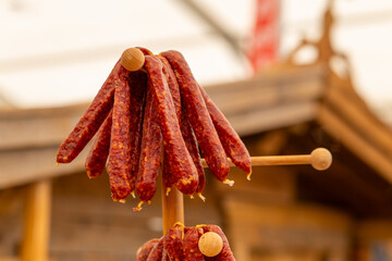 wooden pole with a bunch of sausages
