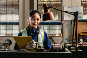 Portrait happy engineer worker with safety eyes protection glasses professional working with metal lathe milling machine heavy industry factory. - 801368871
