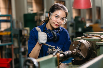 Portrait engineer worker thumbs up professional working in metal lathe milling machine heavy...