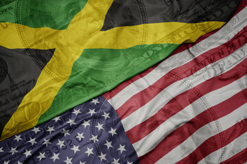 waving colorful flag of united states of america and national flag of jamaica.
