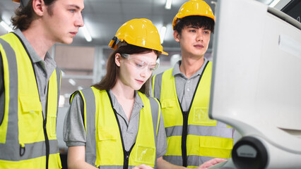 Professional engineering or technician team are discussing or having a conversation while working on PLC Control panel CNC machine to control the efficiency of robotic machinery to maintenance program