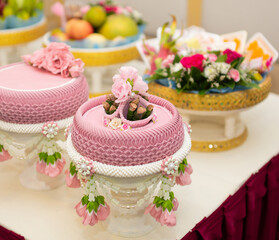 A pink tray with areca nuts and betel leaves is reserved for copying space.