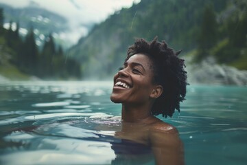 African American woman laughing joyously while enjoying a cold water therapy session in a natural mountain lake, , moody lighting