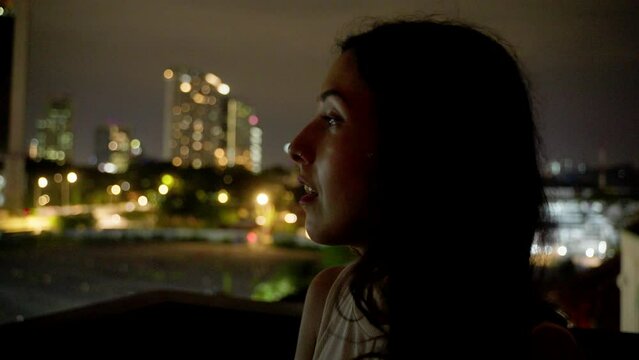 Woman with city skyline in the background night