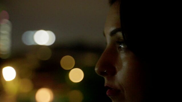 Woman with city skyline in the background night