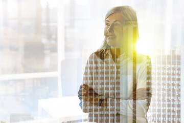 Double exposure of successful businesswoman and cityscape