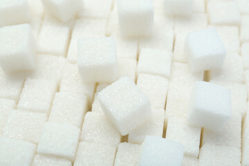 White sugar cubes as background, closeup view