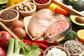 Raw chicken, salmon, seeds and other healthy food, closeup