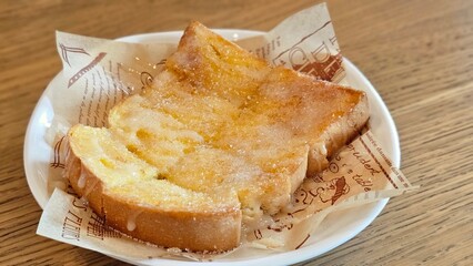 Roasted bread with butter, sweet condensed milk ans sugar.